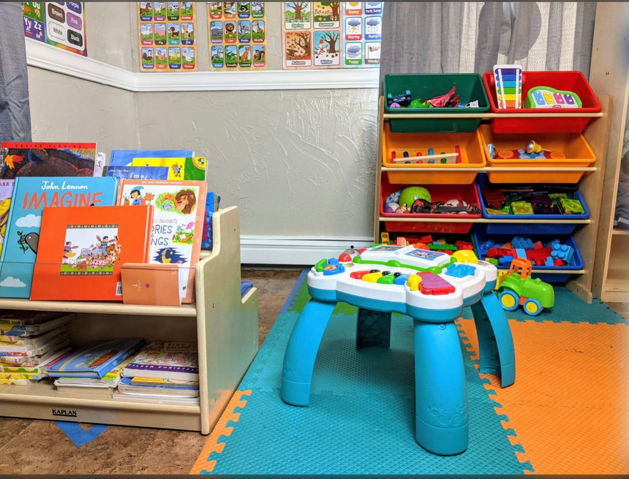 Children's play area with books, toys, and an activity table