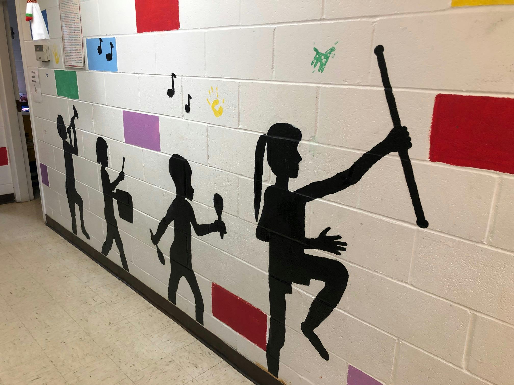 Mural of people playing musical instruments and holding a flag