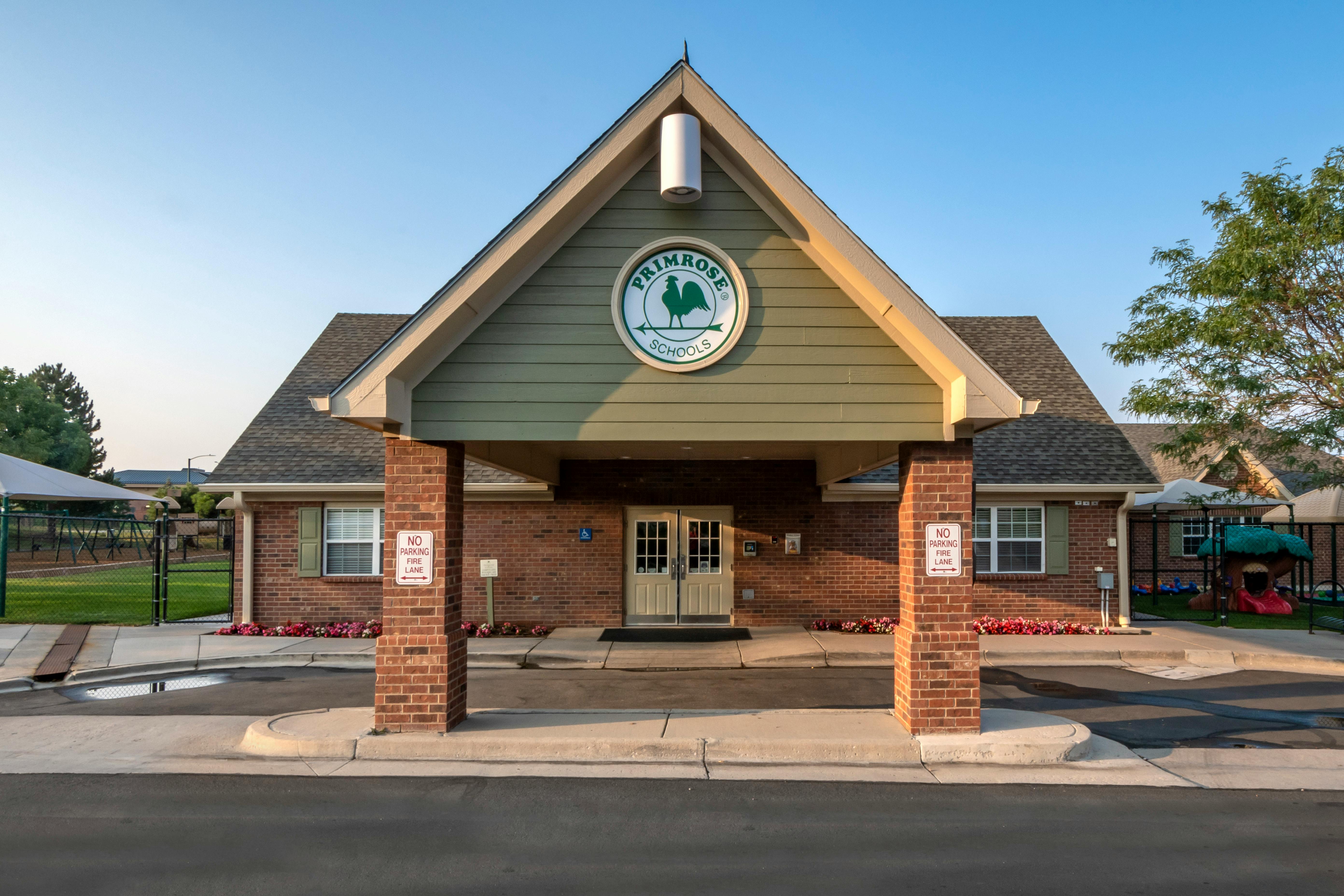 Front exterior of a Primrose Schools building with a playground nearby