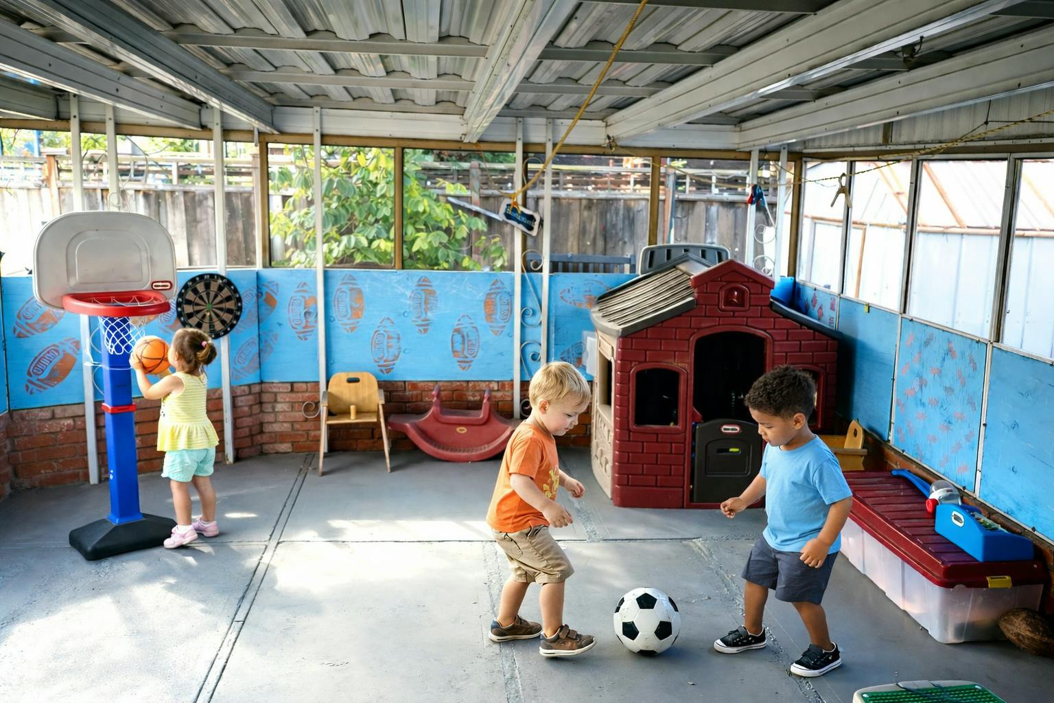 Children playing with a basketball and soccer ball in a playroom