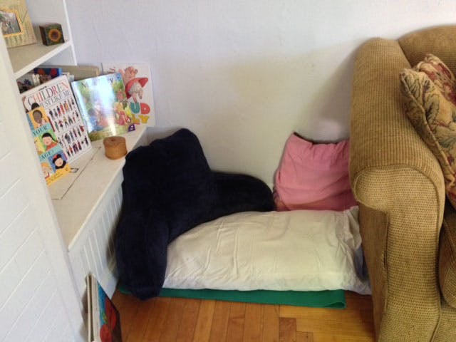 Pillows on the floor next to a couch