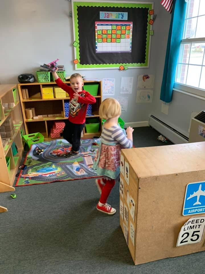 Two children playing in a classroom