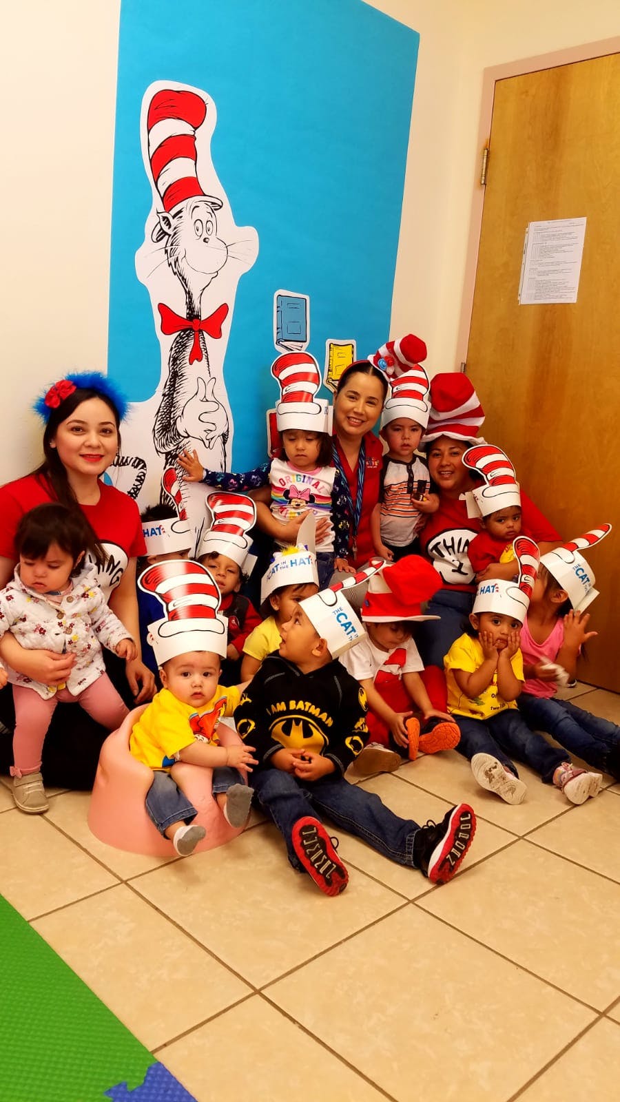 Adults and children wearing red and white striped hats