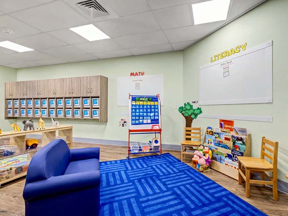 Classroom with children's furniture, educational displays, and storage units