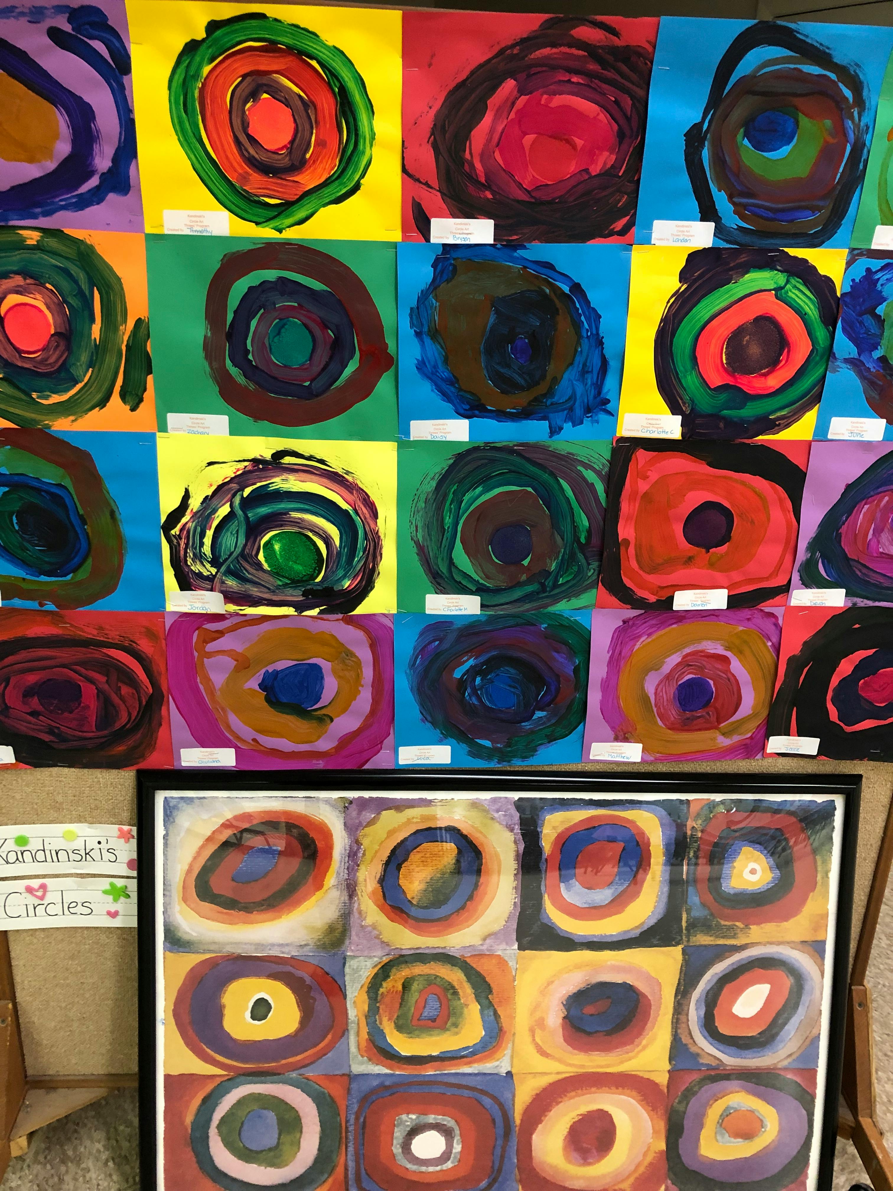 Multiple colorful paintings of concentric circles displayed on a wall