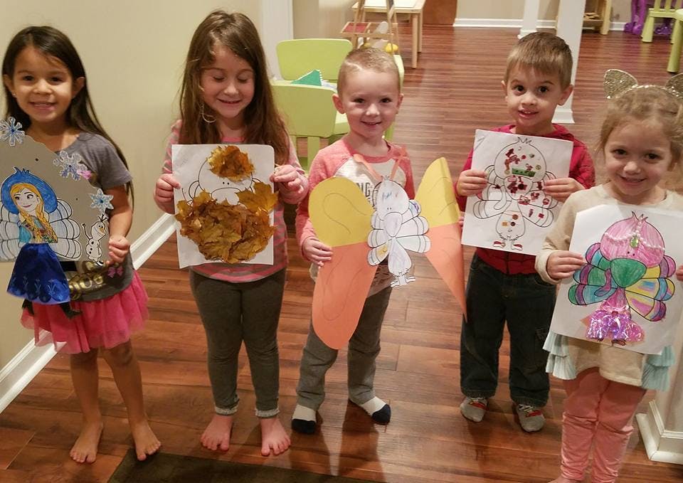 Five children holding up their artwork