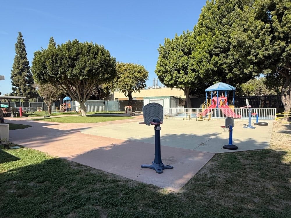 Playground area with small basketball hoops and a colorful play structure