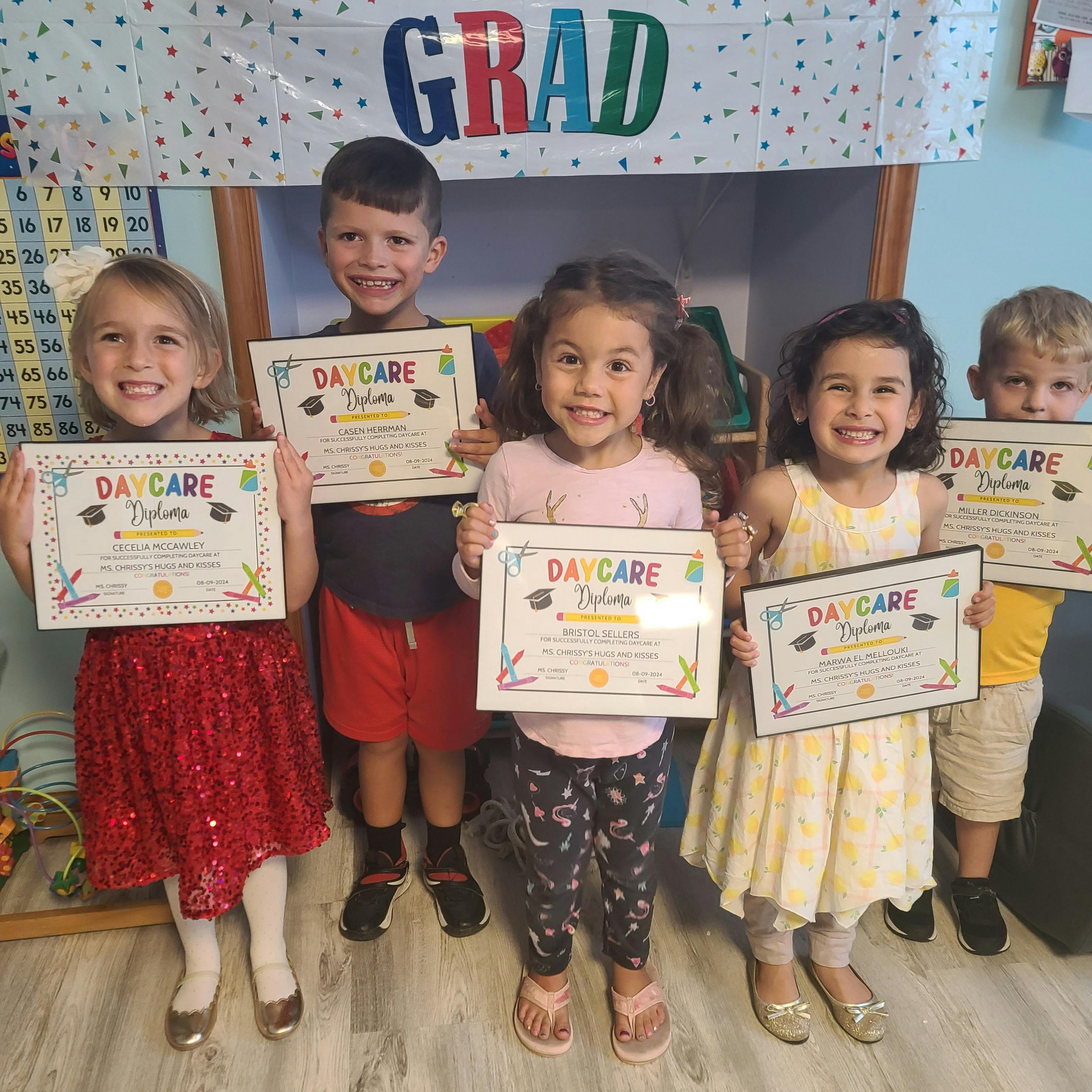 Five children holding up "Daycare Diploma" certificates