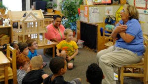 Adult speaking to children in a classroom