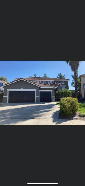 House with two garage doors and a driveway