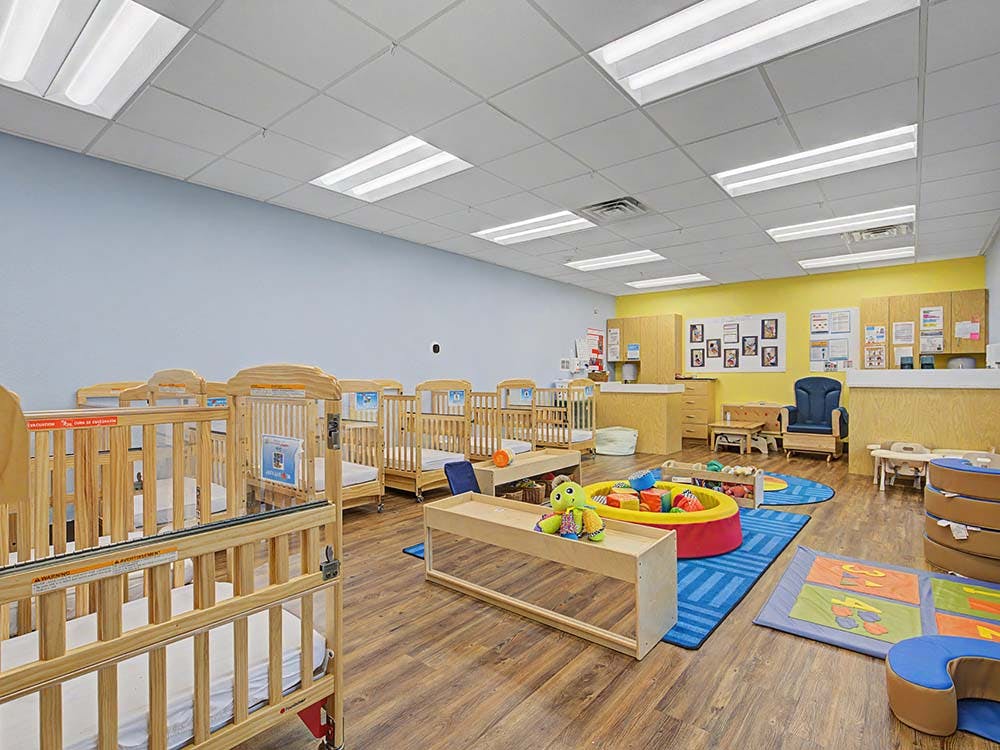 Baby room with many cribs and play area