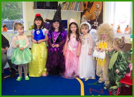 Six children in costumes standing together