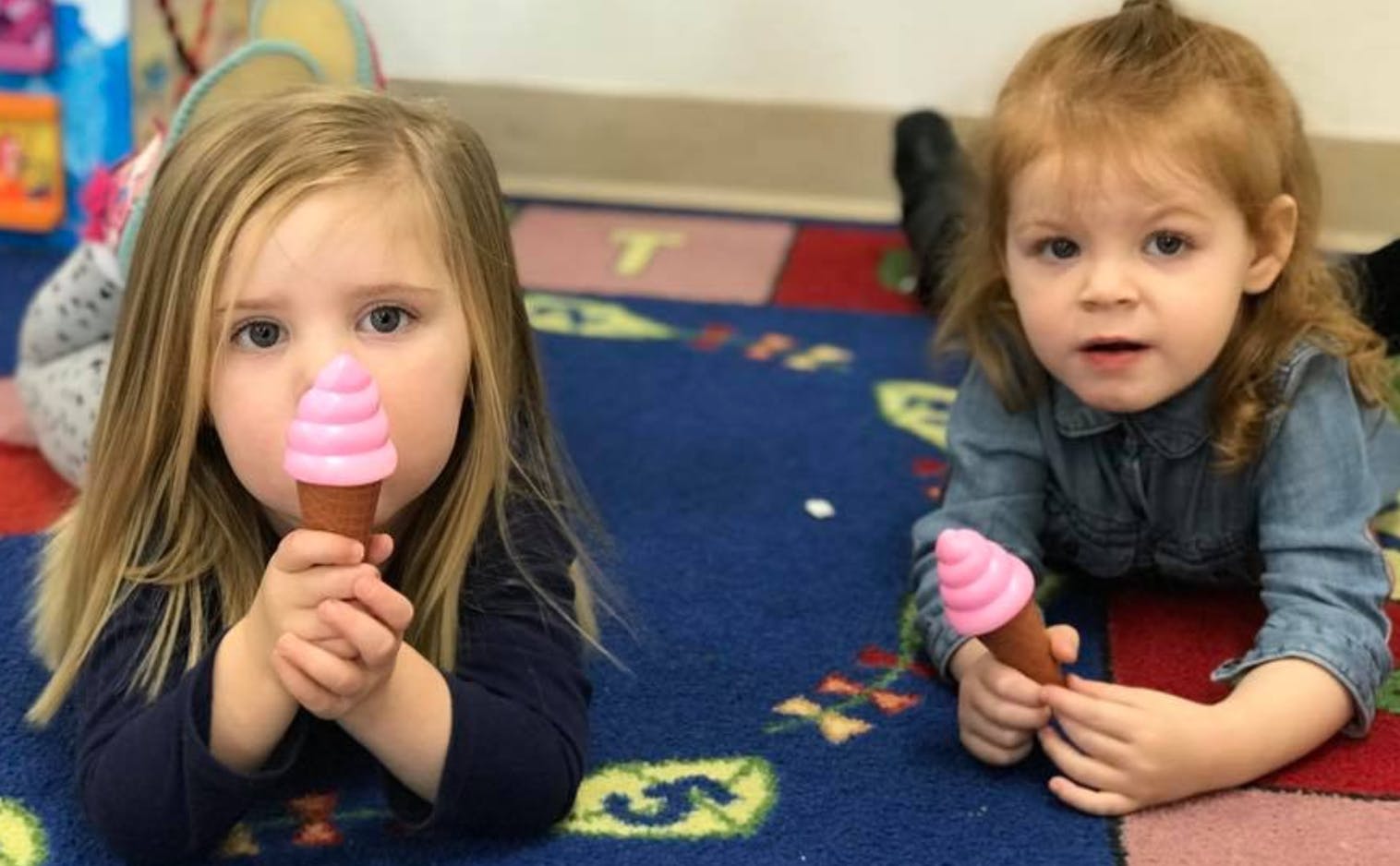 Two children holding toy ice cream cones