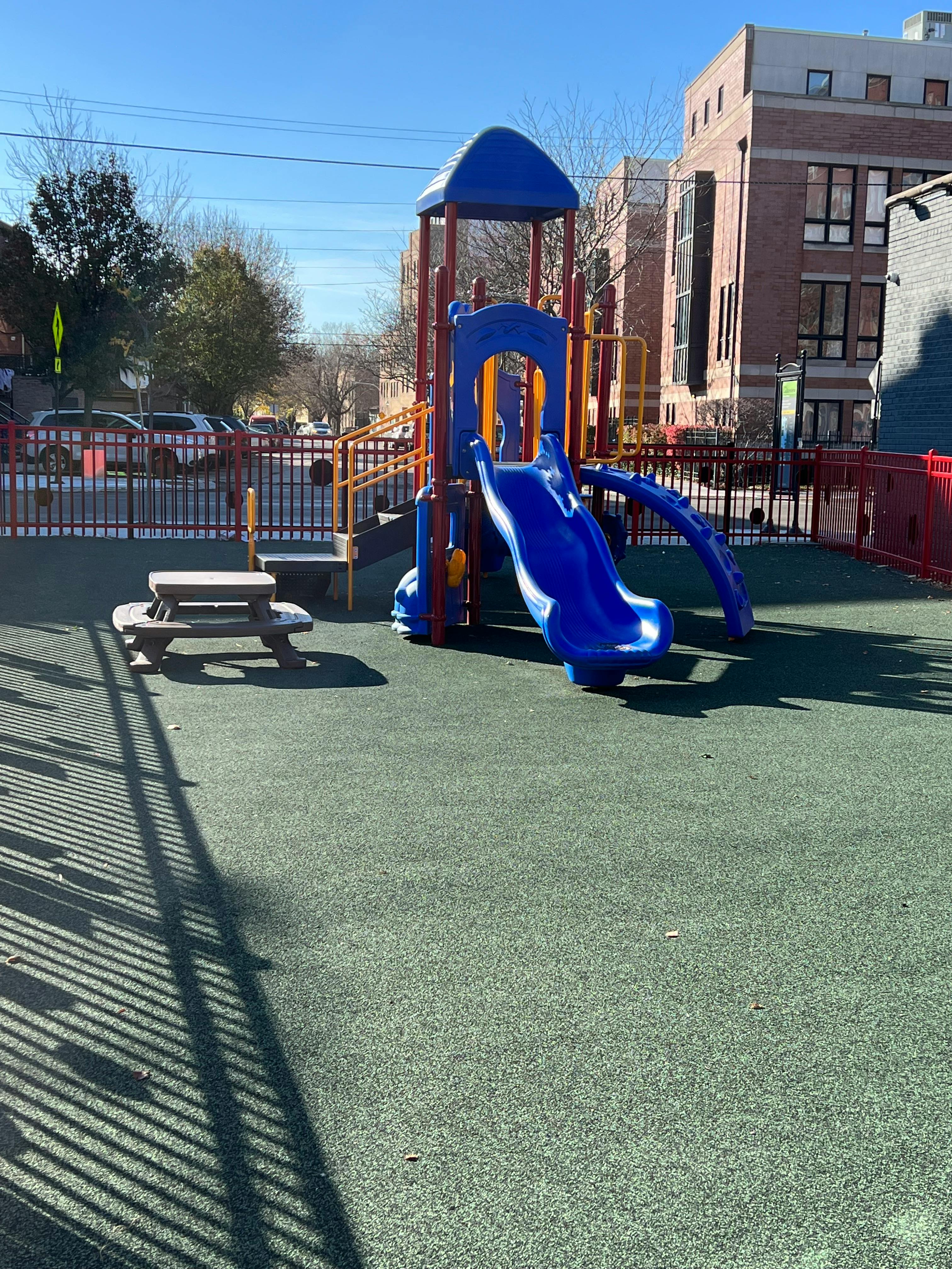 Playground with blue slide and picnic table