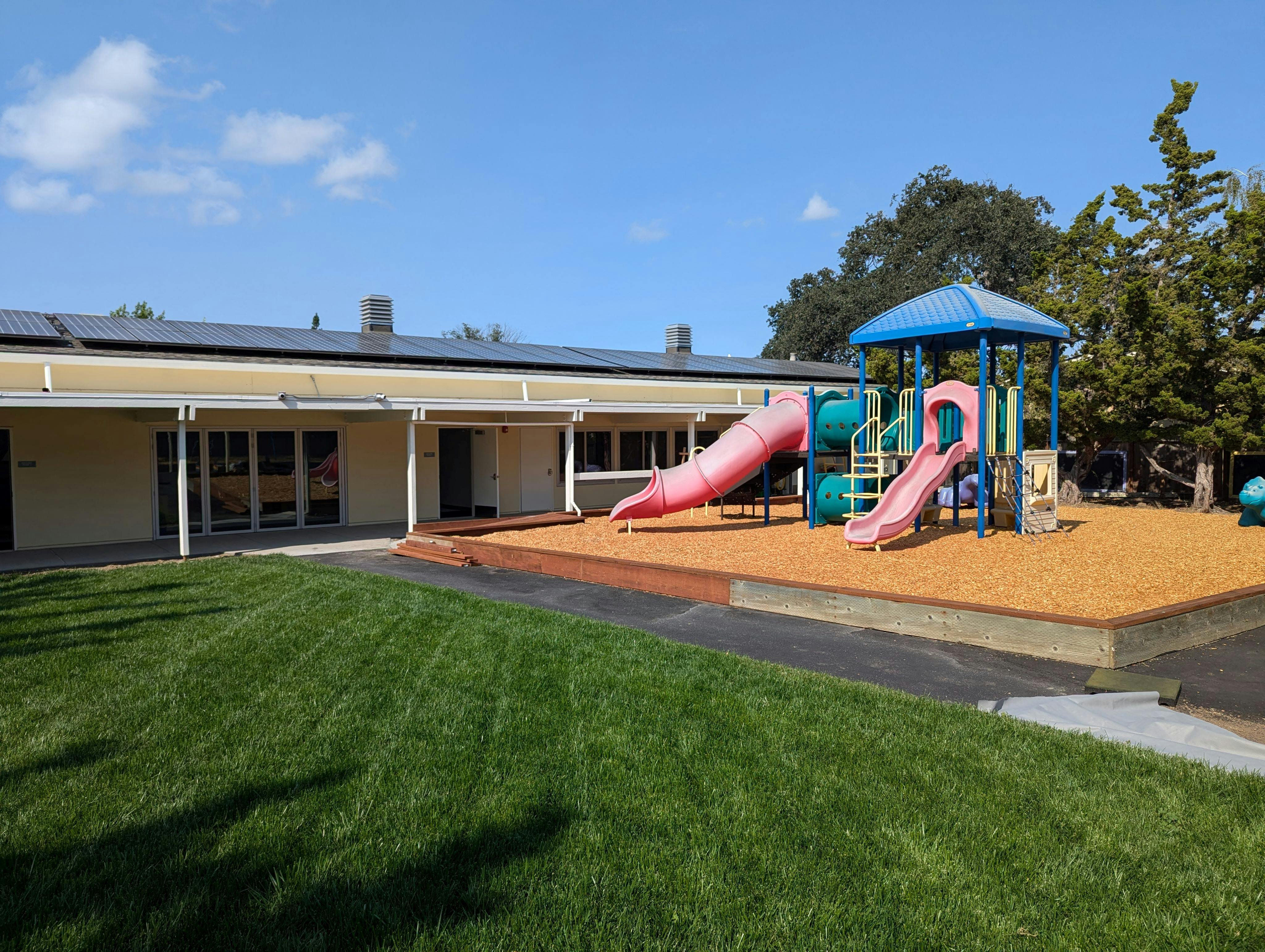 Playground with slides next to a building