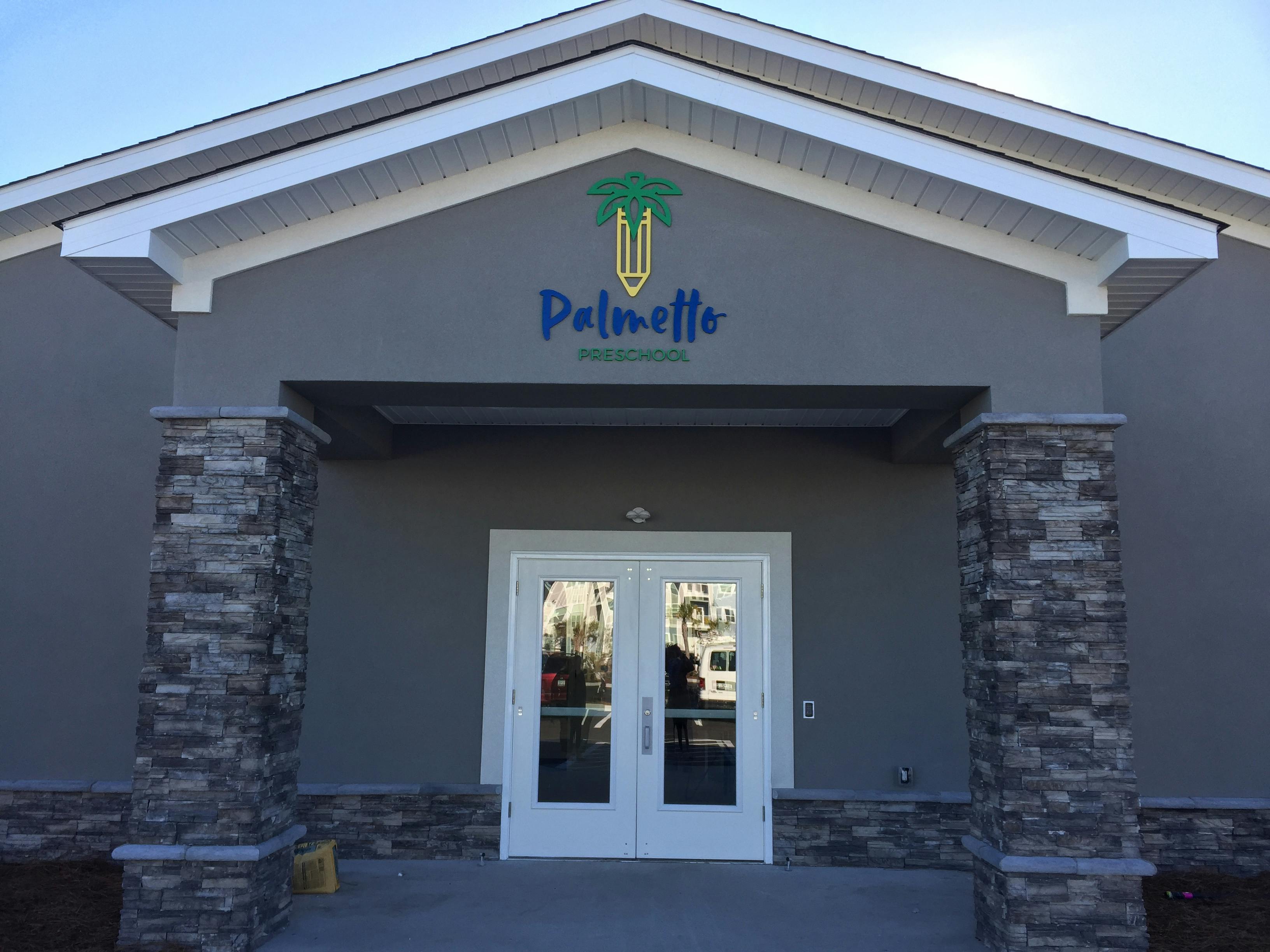 Entrance to Palmetto Preschool with a palmetto tree and pencil logo