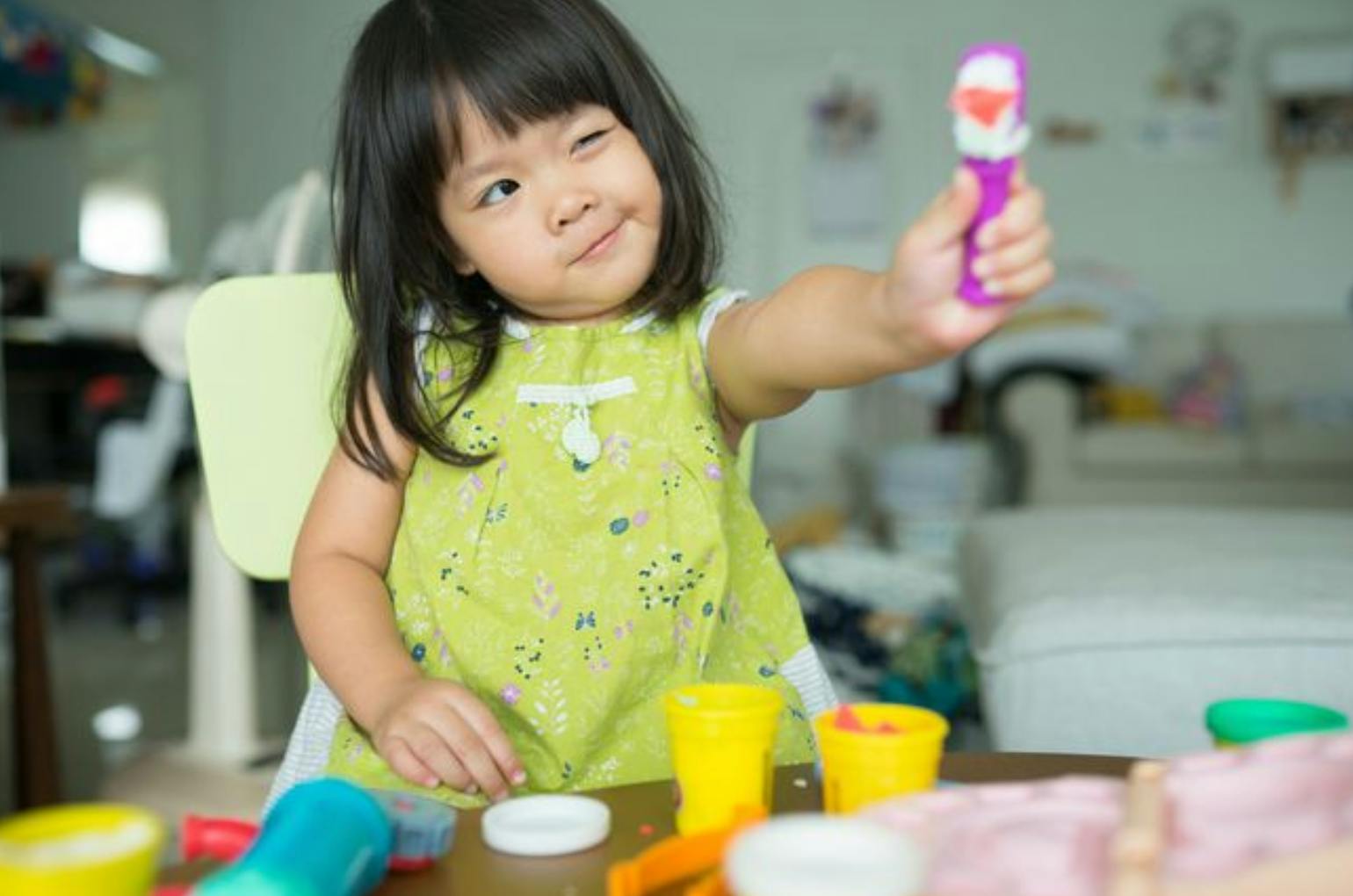 Child holding up a toy