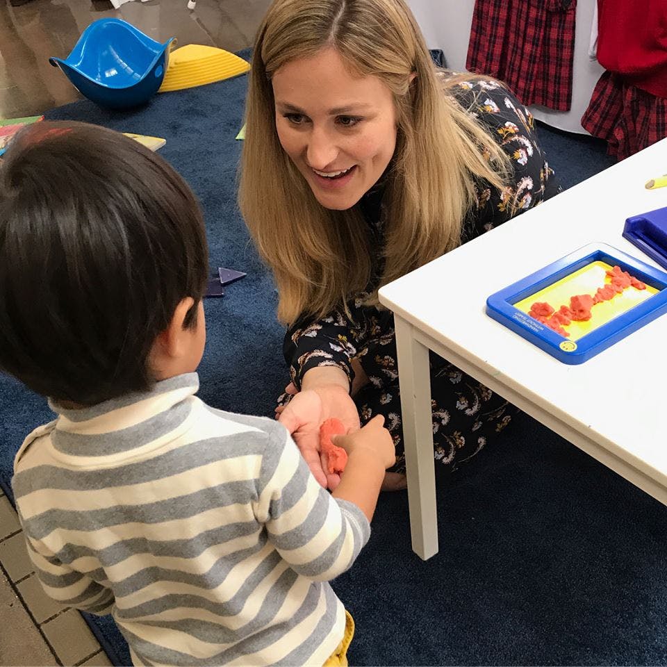 Person interacting with a child on the floor
