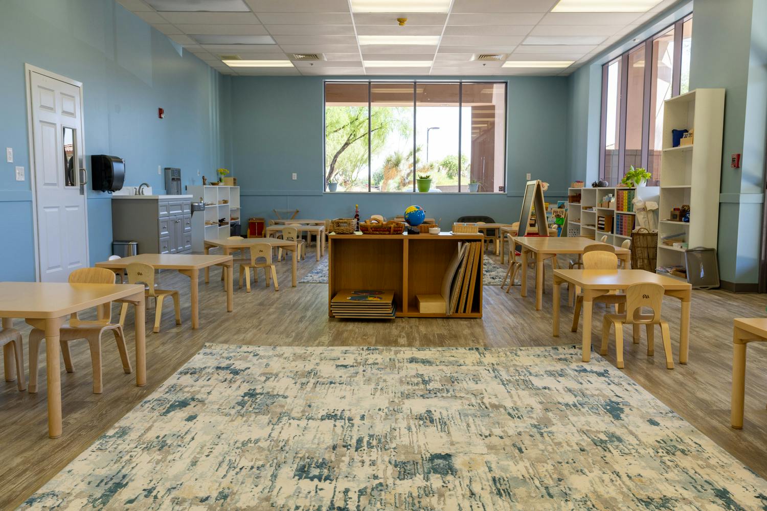 Empty classroom with small tables and chairs