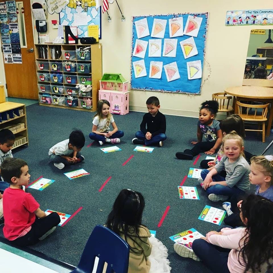 Children sitting on the floor in a classroom