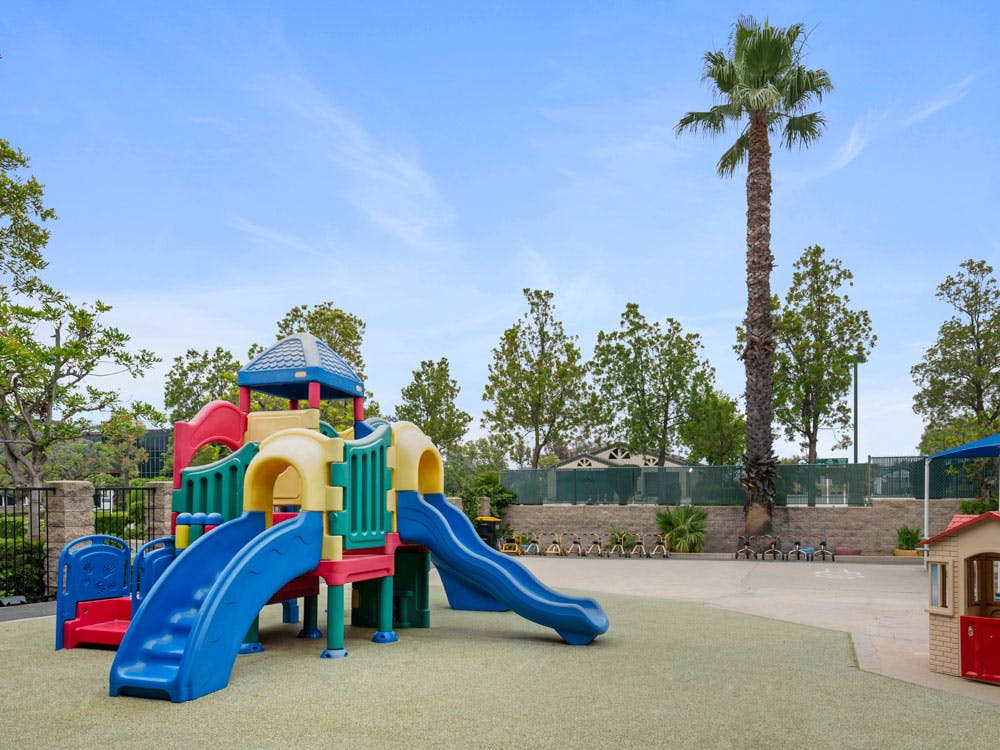 Playground with colorful slides and structures on soft ground