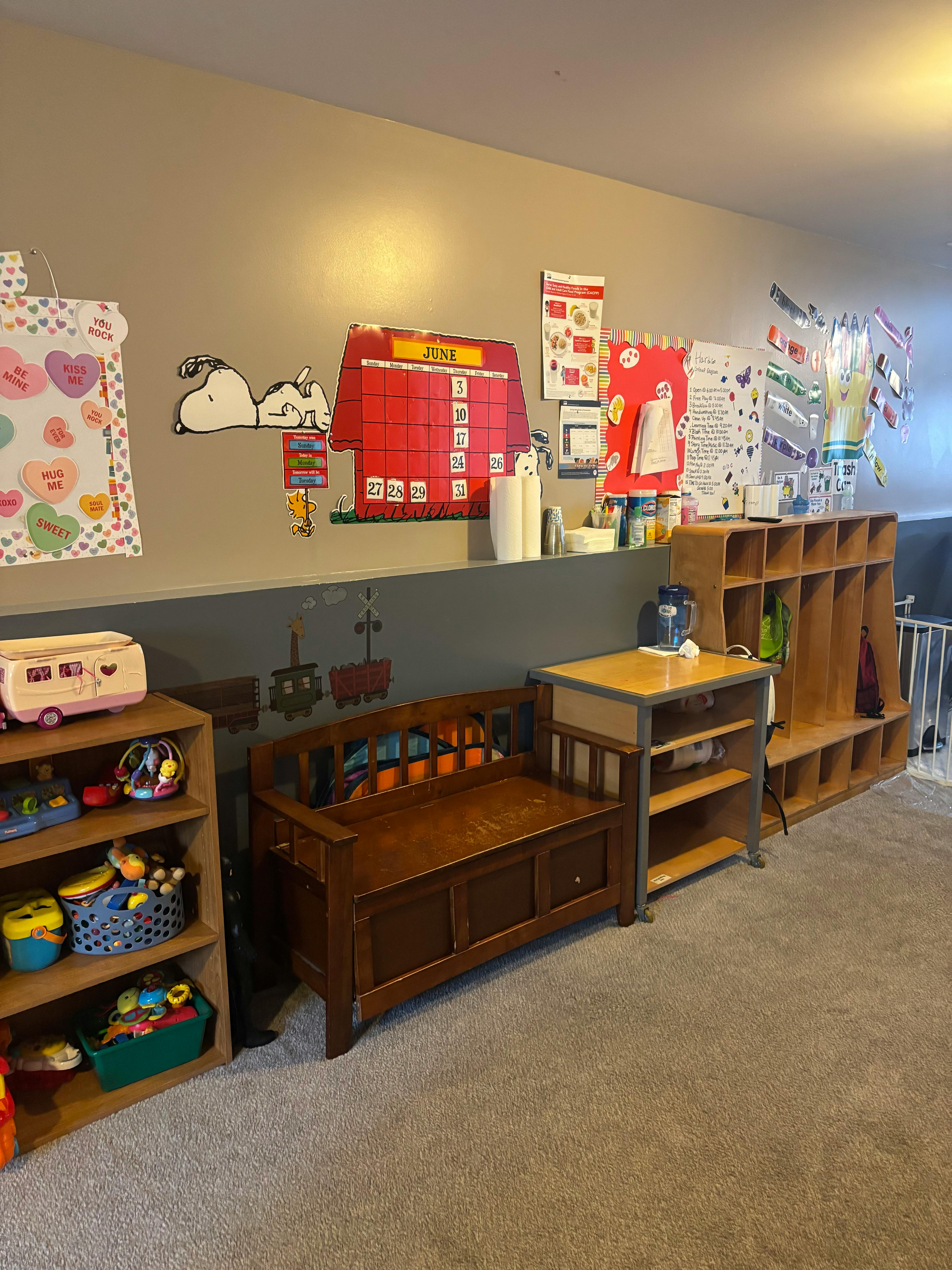 Classroom with cubbies, shelves of toys, and wall decorations