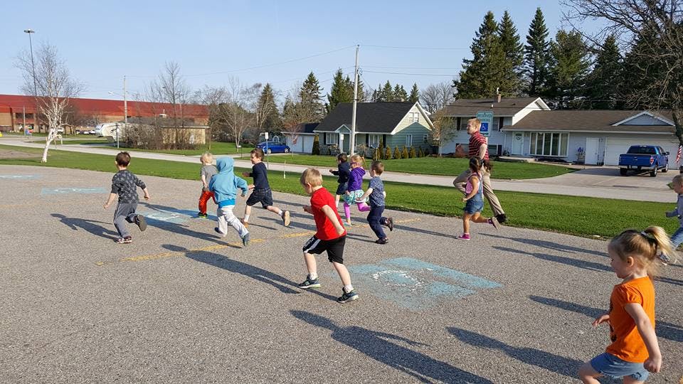 Children running on pavement outdoors