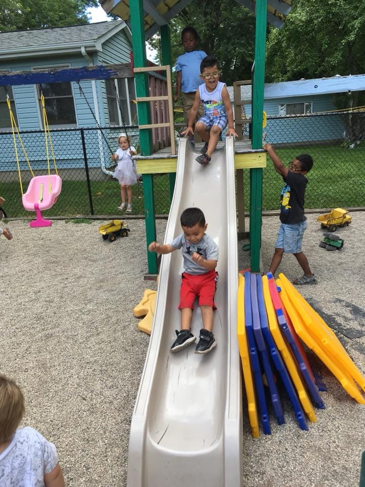 Children playing on a playground slide