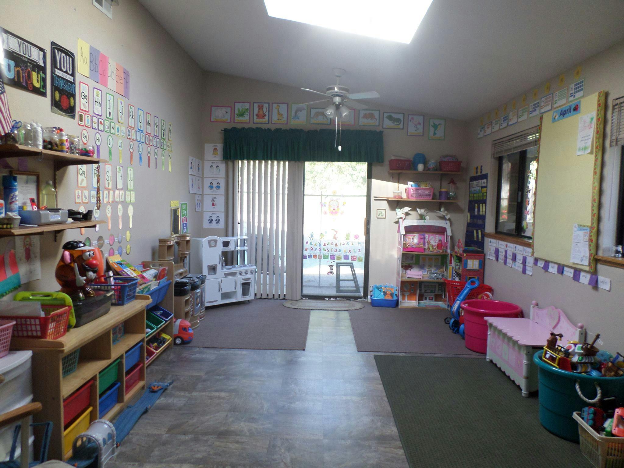 Classroom with toys, shelves, and a door leading outside