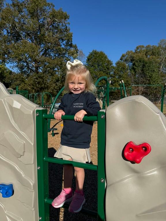 Child climbing on a playground structure