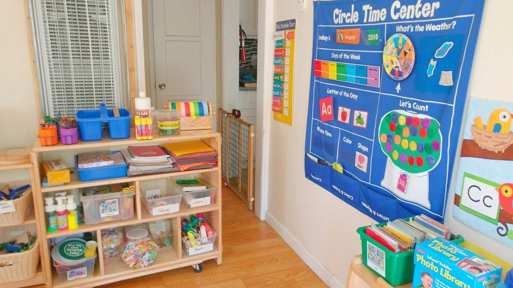 Classroom with a rolling shelf of supplies and a blue Circle Time Center chart