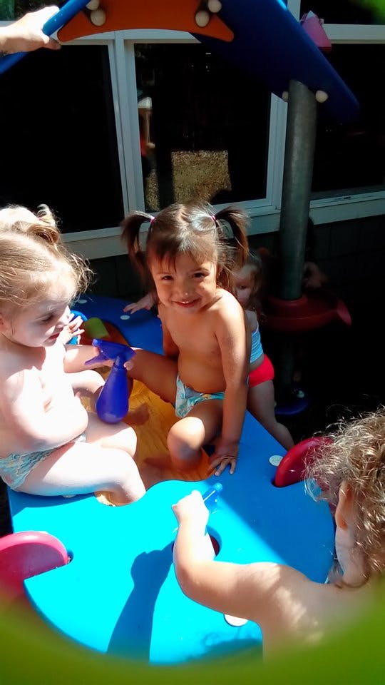 Children playing with a blue toy