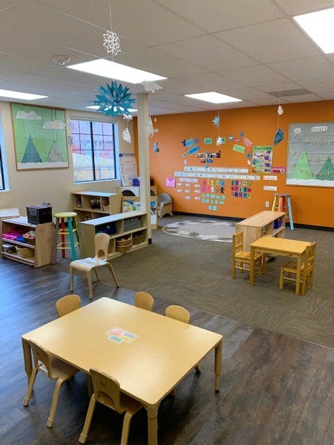 Empty classroom with small tables and chairs