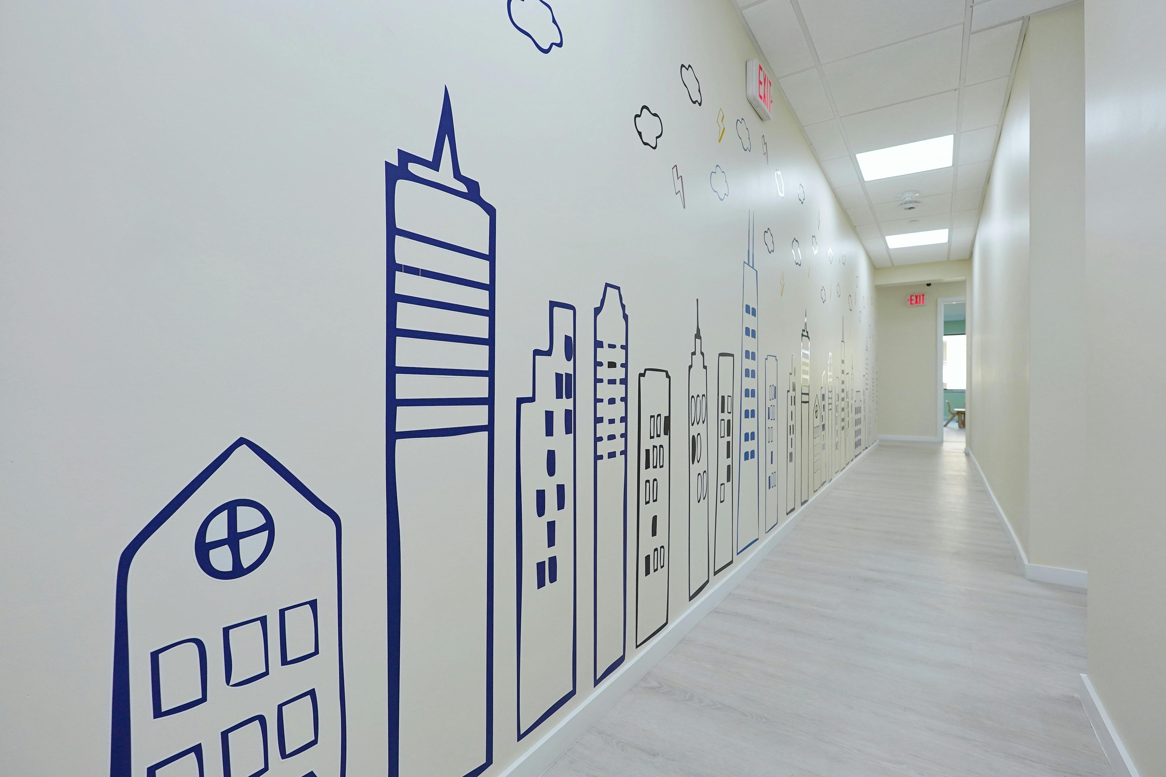 Hallway with a city skyline mural on the wall