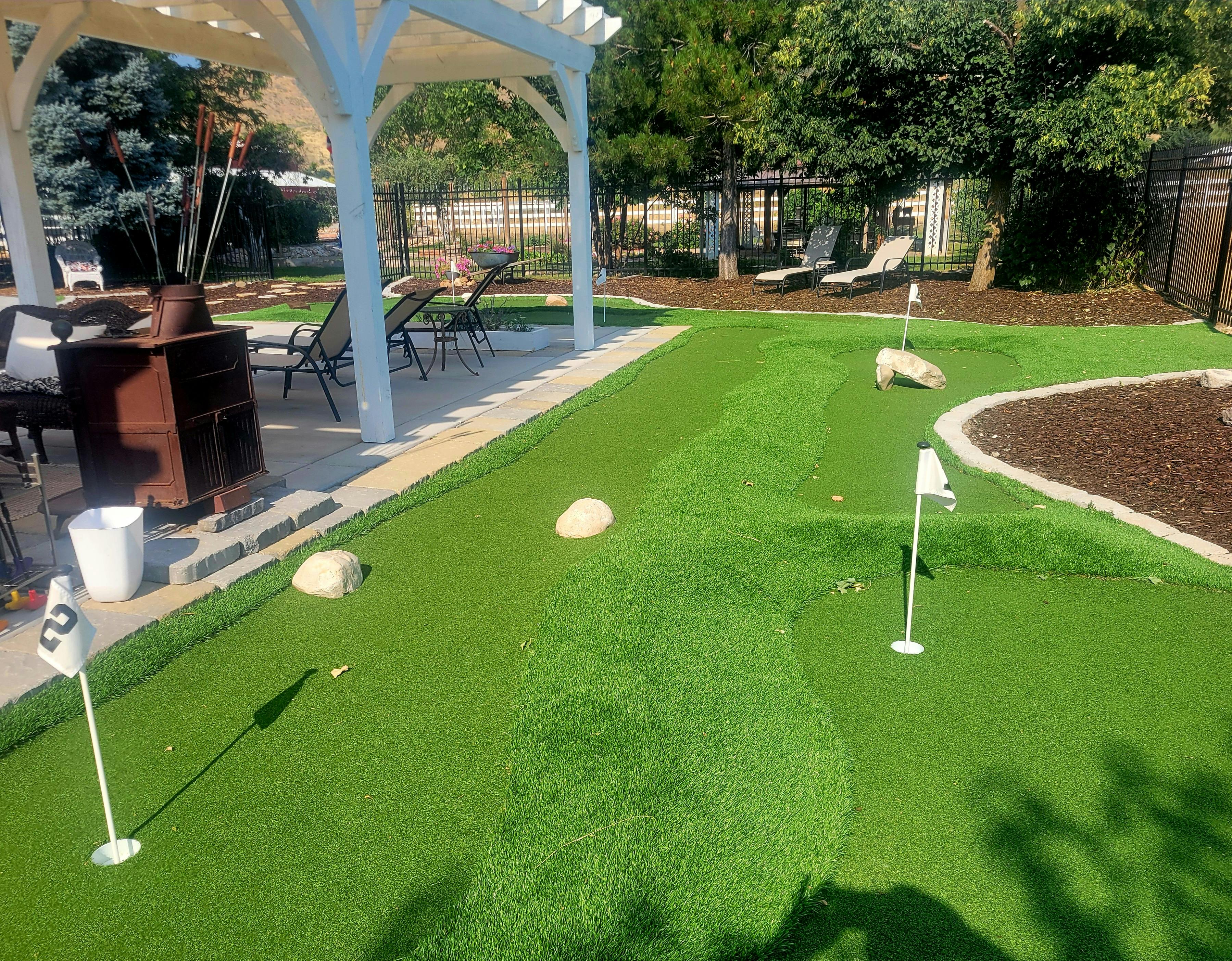 Mini golf course with white flags and a patio area