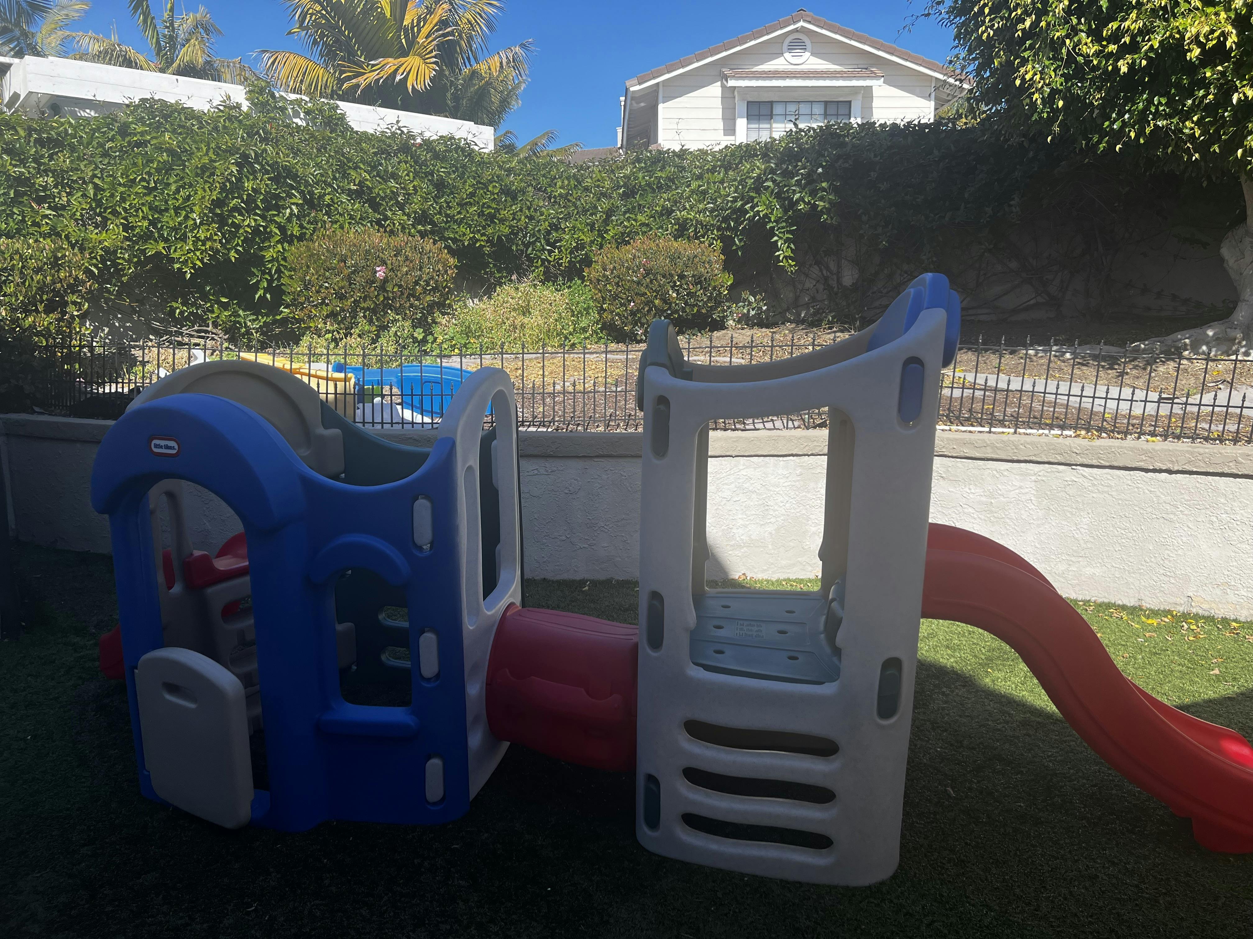 Children's outdoor play structure with a slide