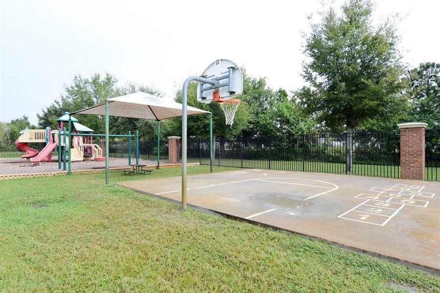Basketball court and playground with slides and swings