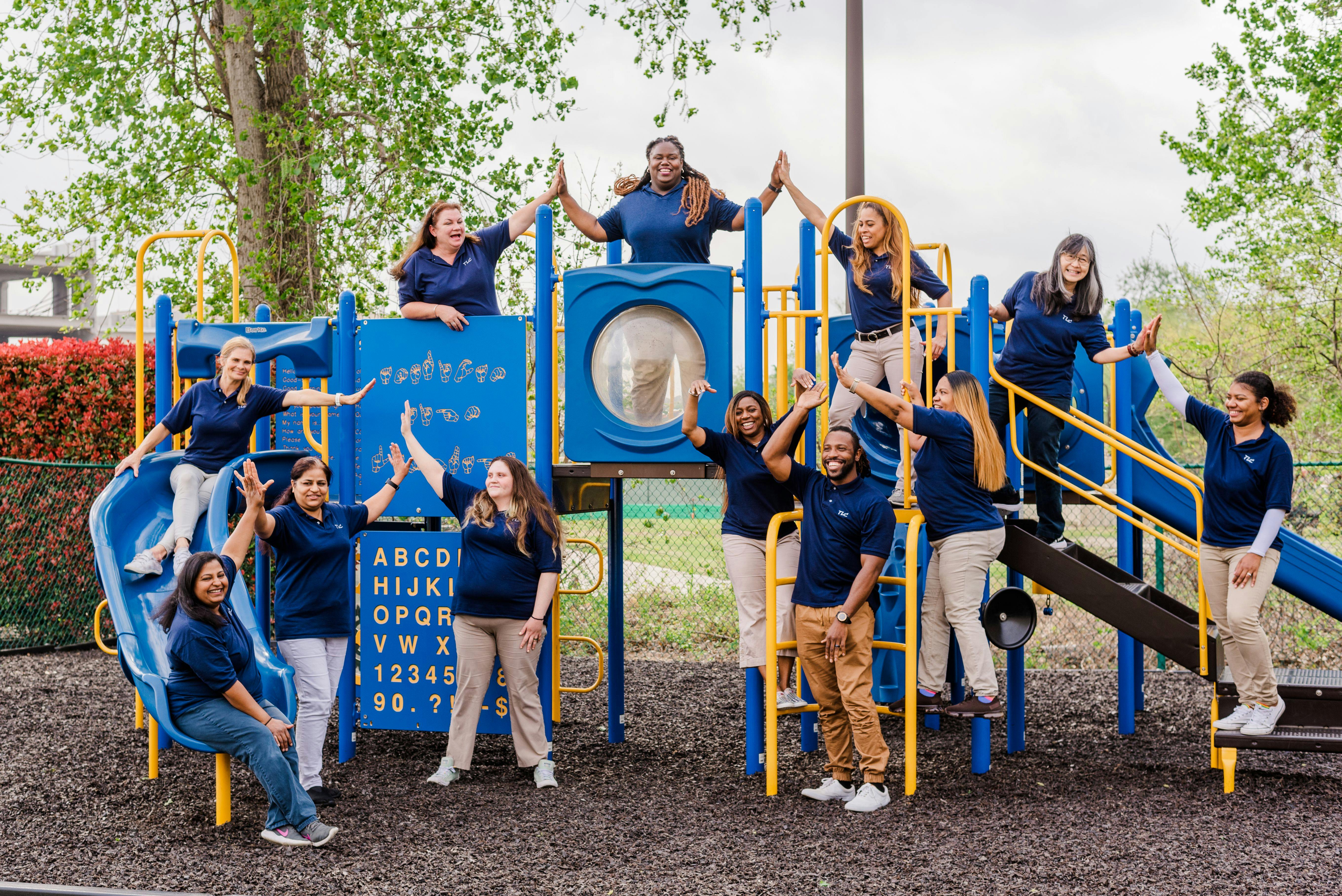Group of people on a blue and yellow playground structure