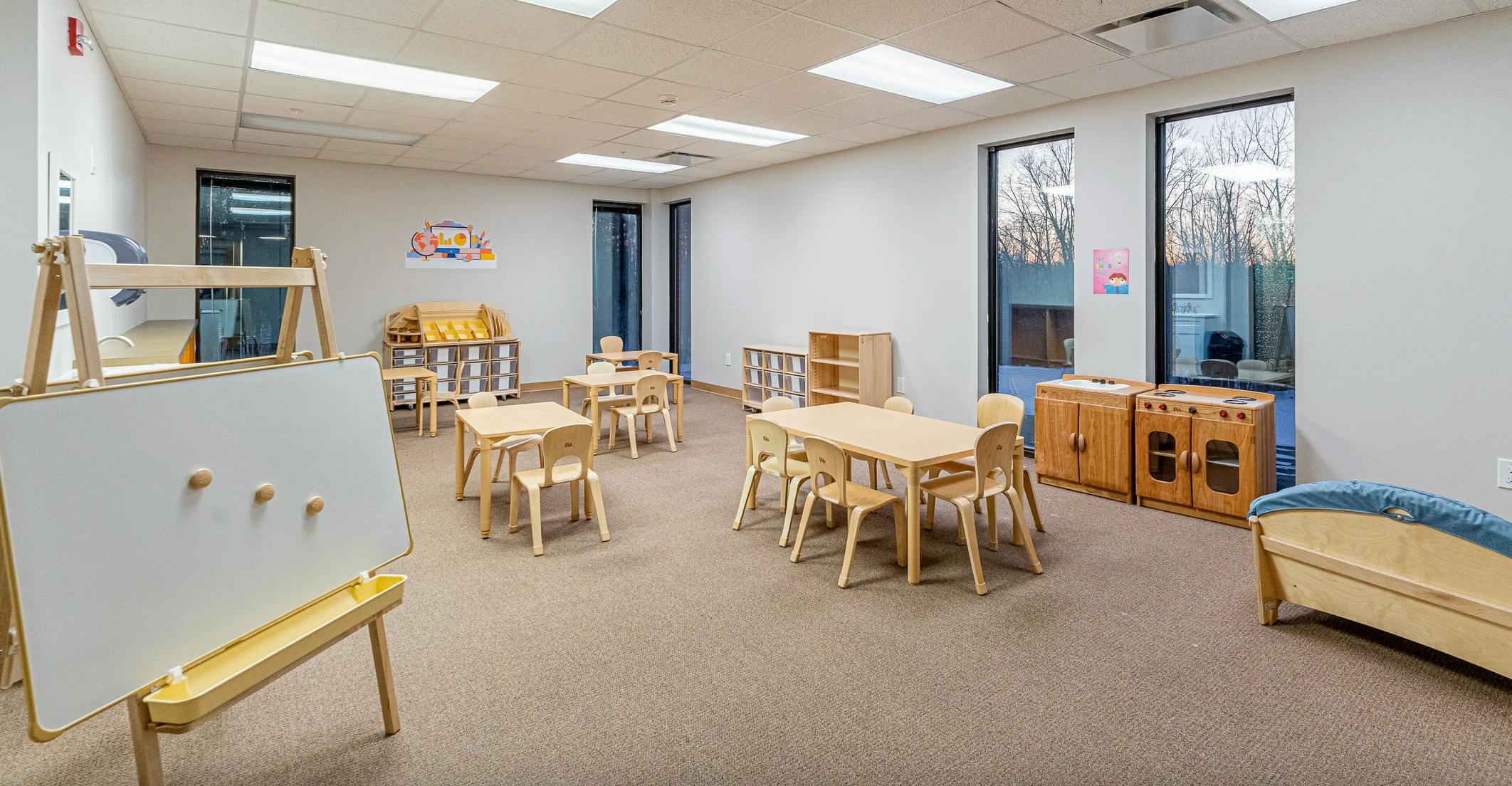 Empty classroom with small tables and chairs