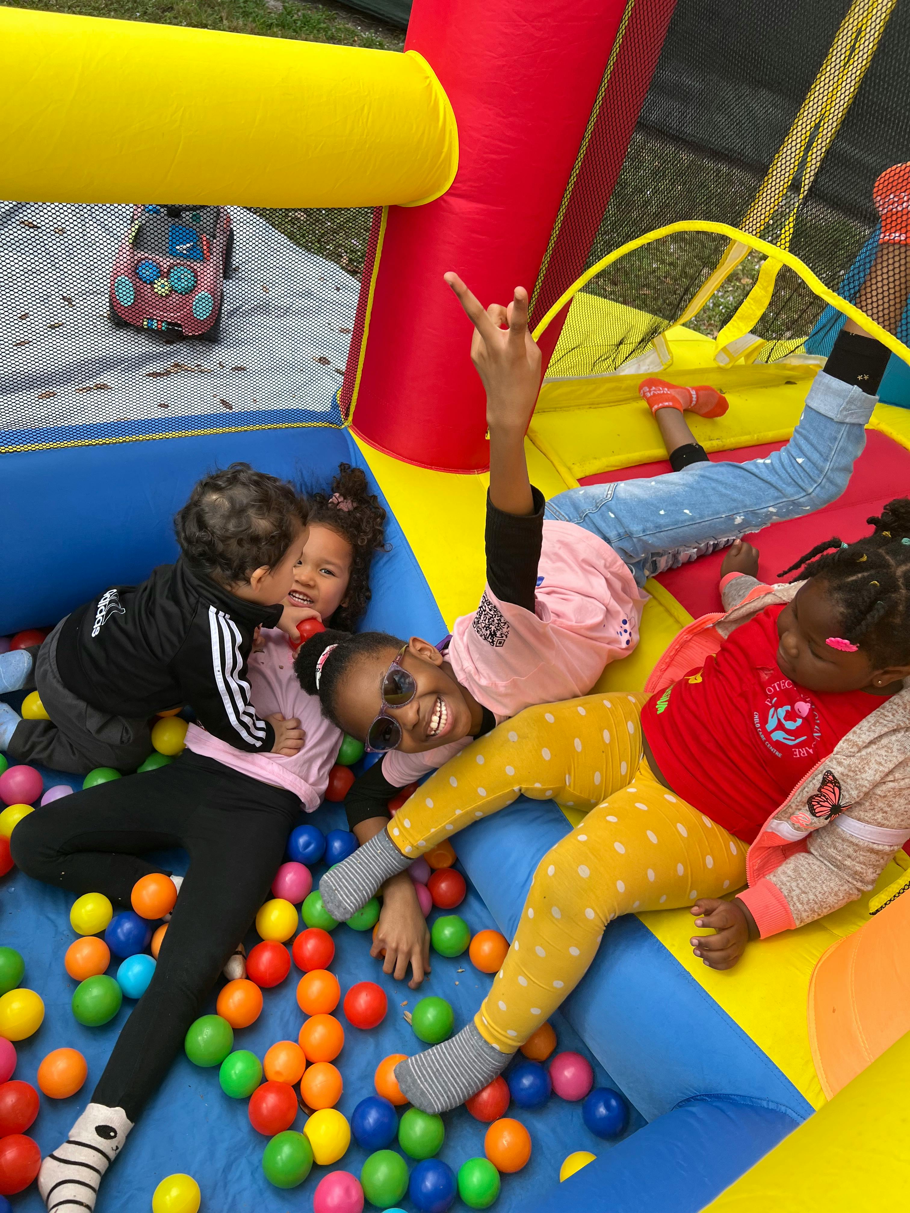 Children playing in a ball pit inside an inflatable bounce house