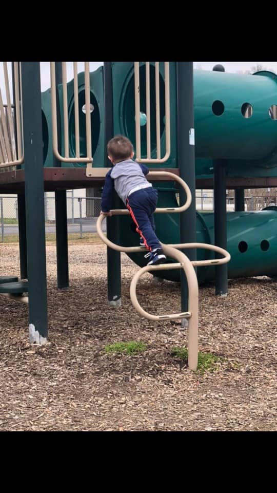 Child climbing on playground equipment