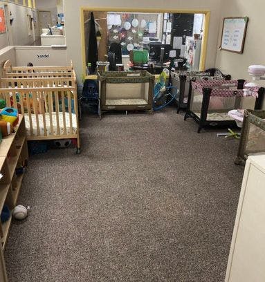 Multiple cribs and playpens in a room