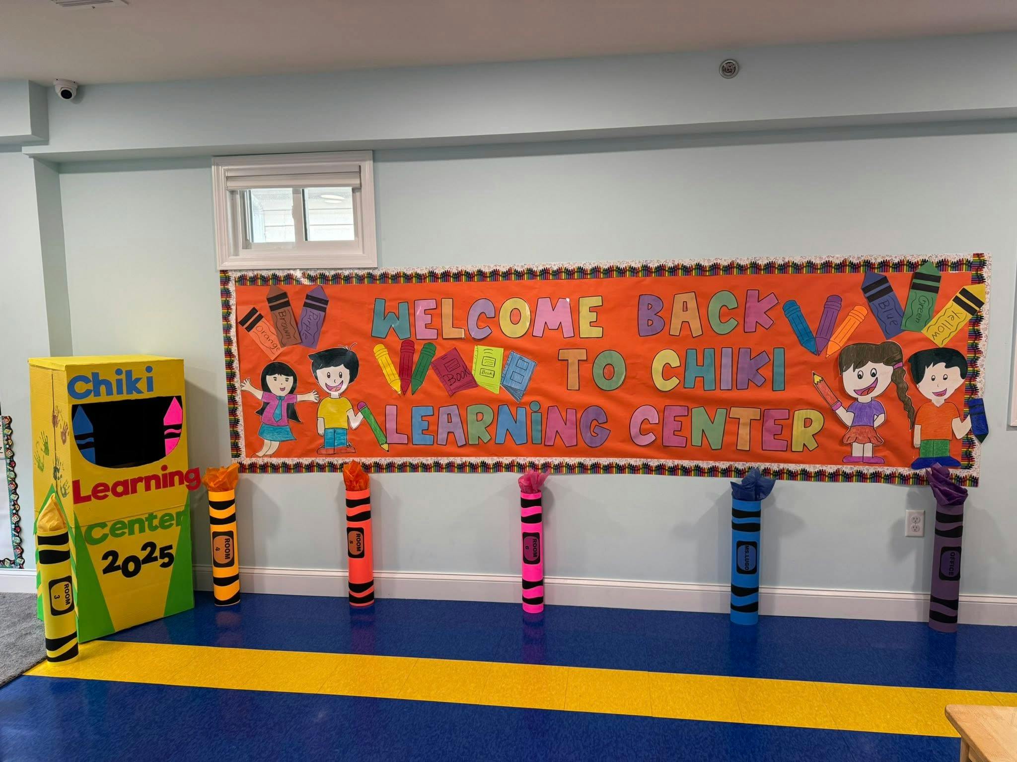 Welcome Back to Chiki Learning Center banner with crayon decorations