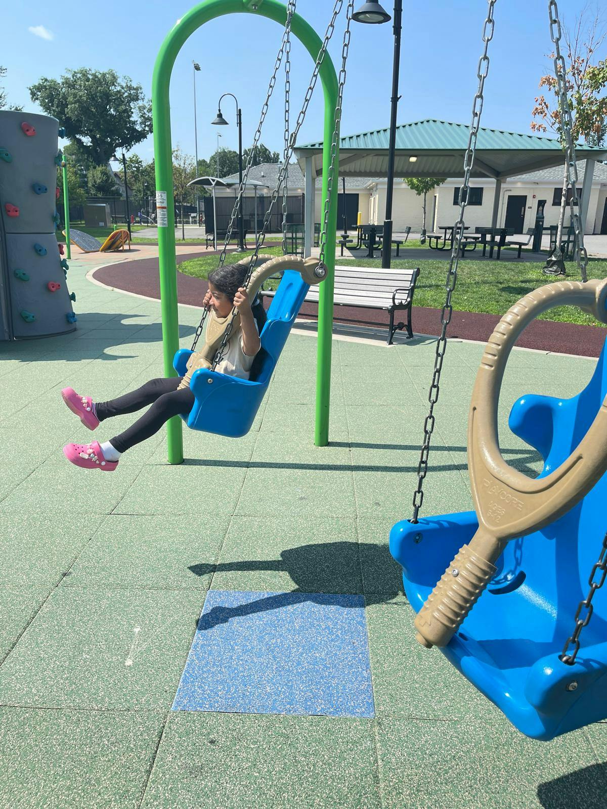 Child swinging on a playground swing set