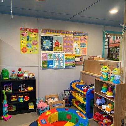 Playroom with shelves of toys, colorful posters on the wall
