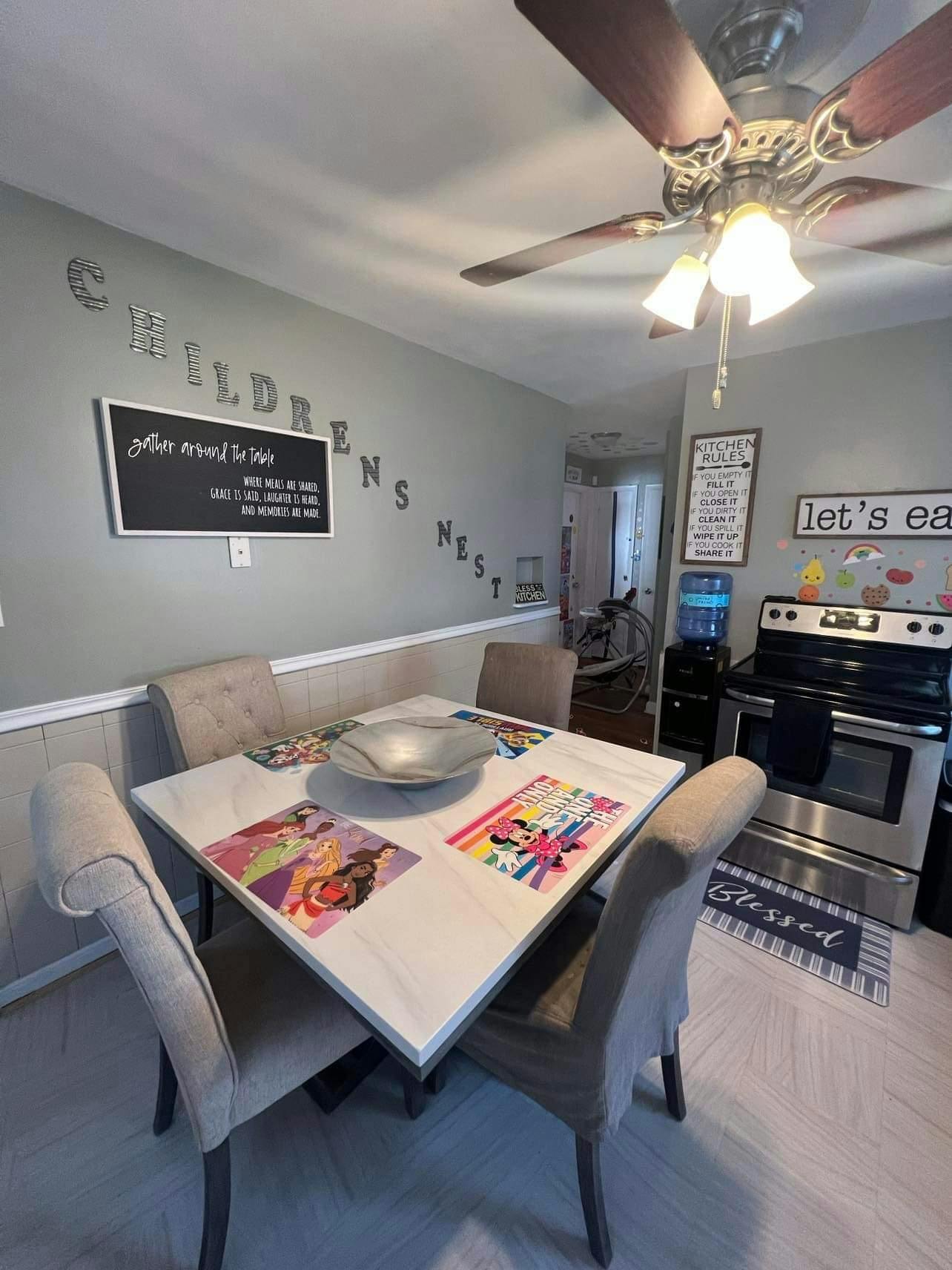Dining area with a table, chairs, and kitchen appliances