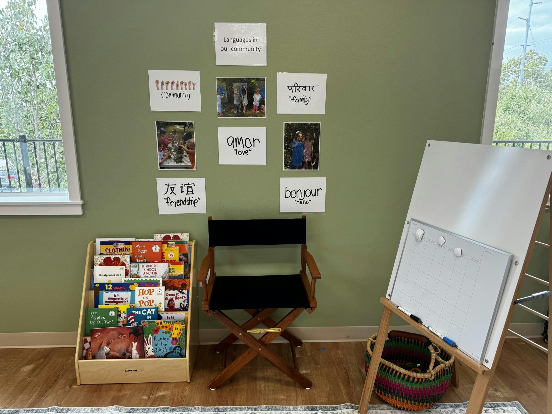 Classroom with a bookshelf, chair, whiteboard, and language cards on the wall