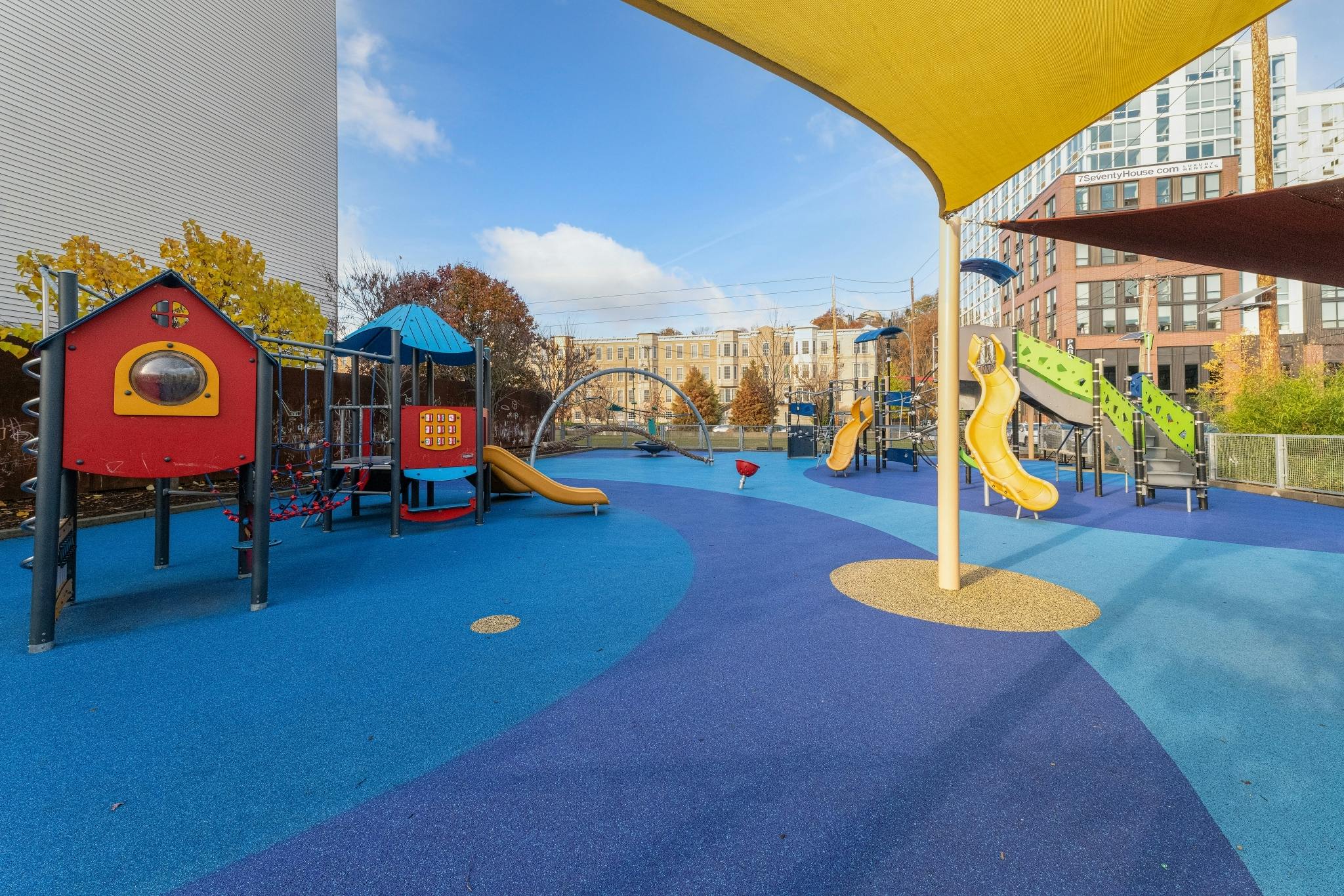 Outdoor playground with slides and play structures on blue ground
