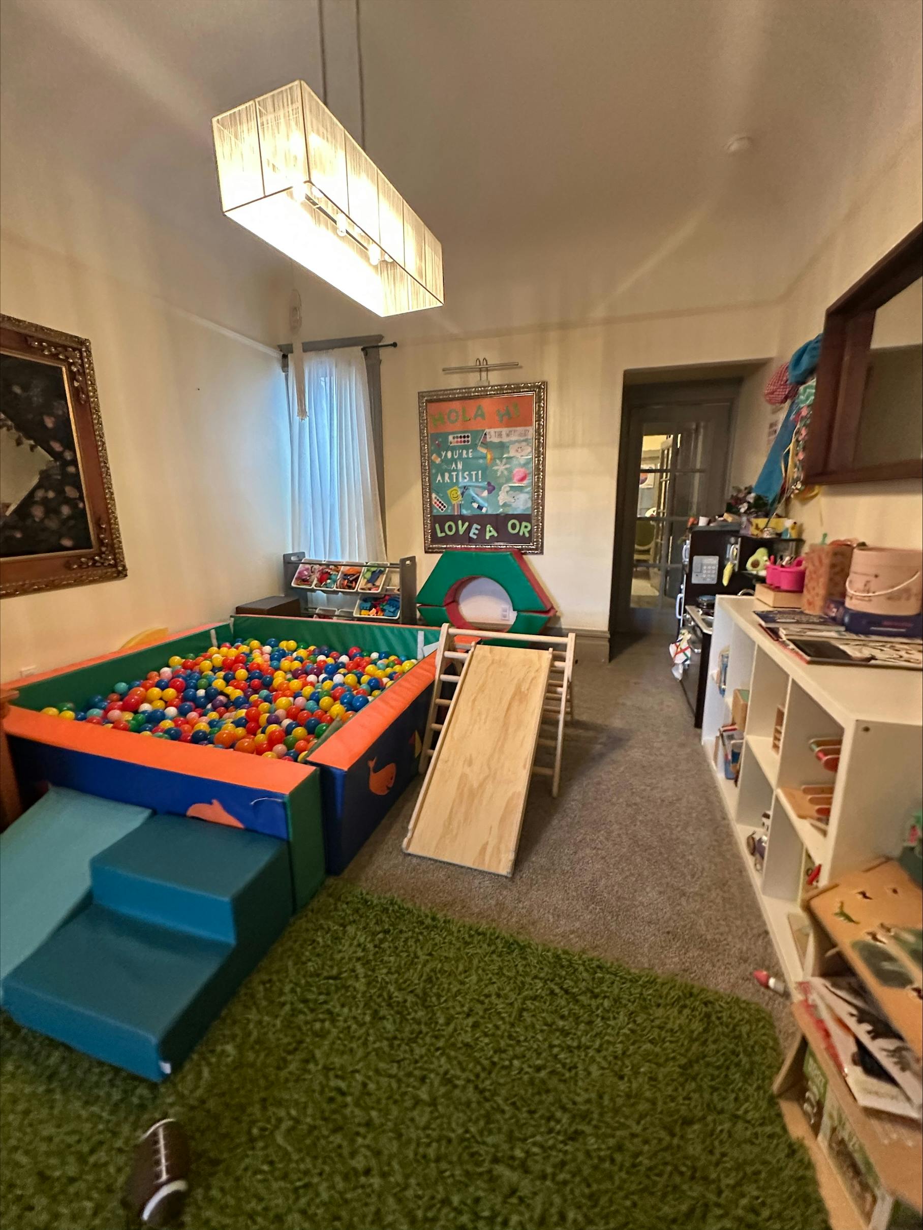 Indoor play area with a ball pit, slide, and soft play steps