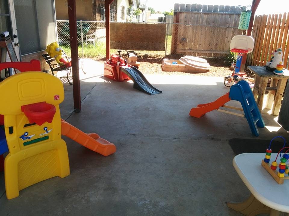 Outdoor patio with multiple colorful slides and play equipment